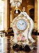 Table clock in refined ceramic, with elegant floral and golden details, handcrafted.